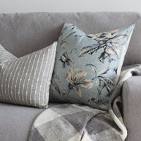 Blue floral and gray stripe pillow cover on sofa