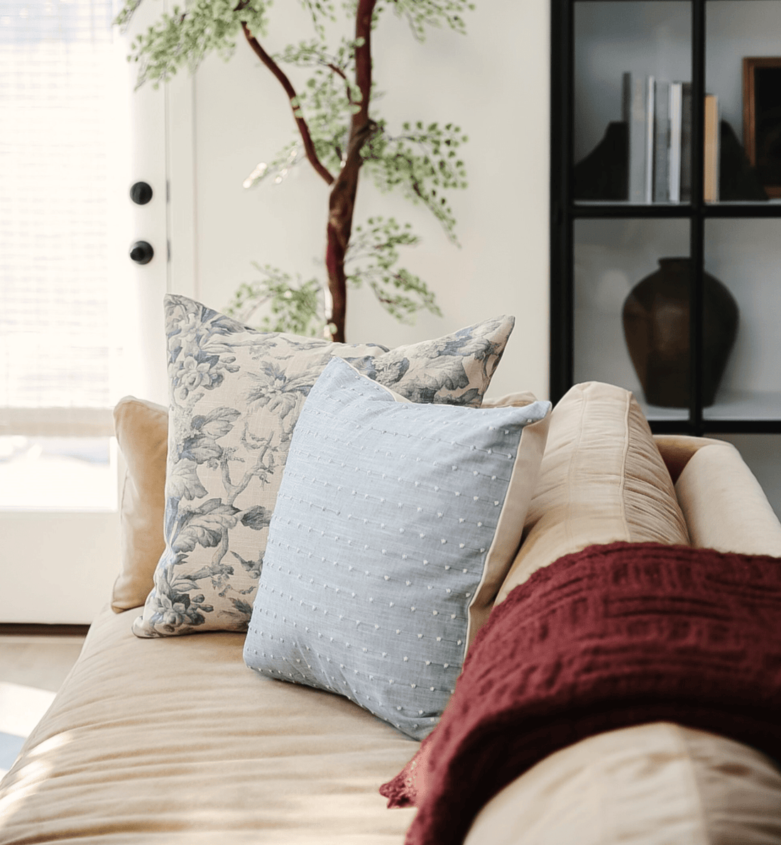 neutral floral and light blue throw pillows