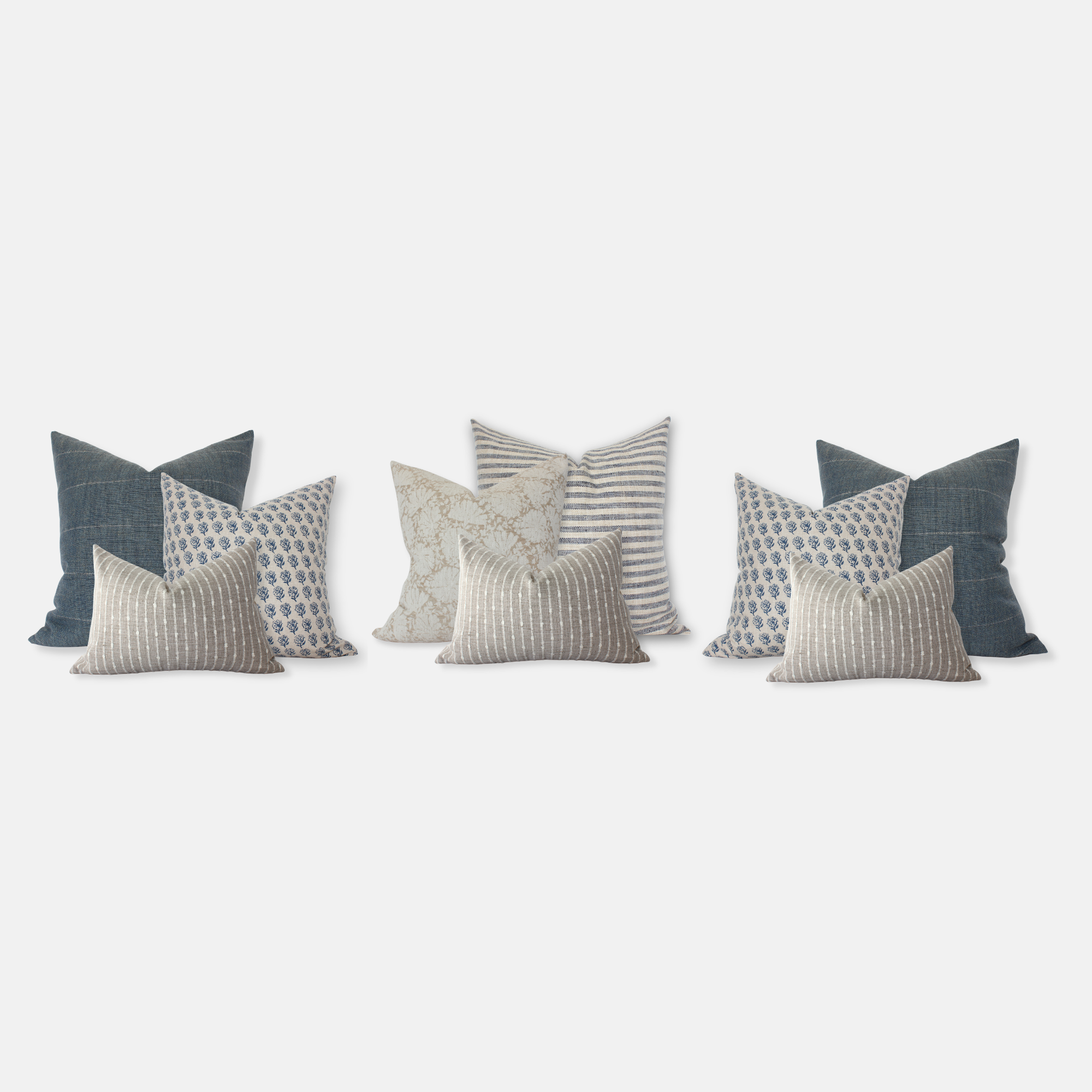 Set of decorative pillows with various patterns in blue and cream gray beige on a white background