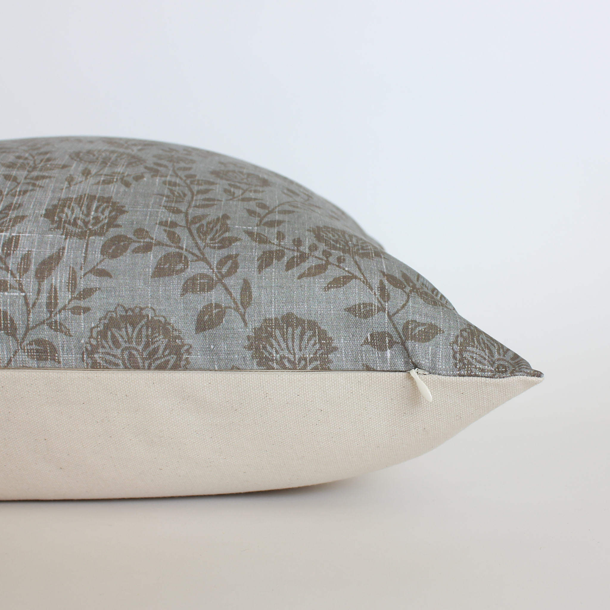 Floral-patterned pillow on a plain background