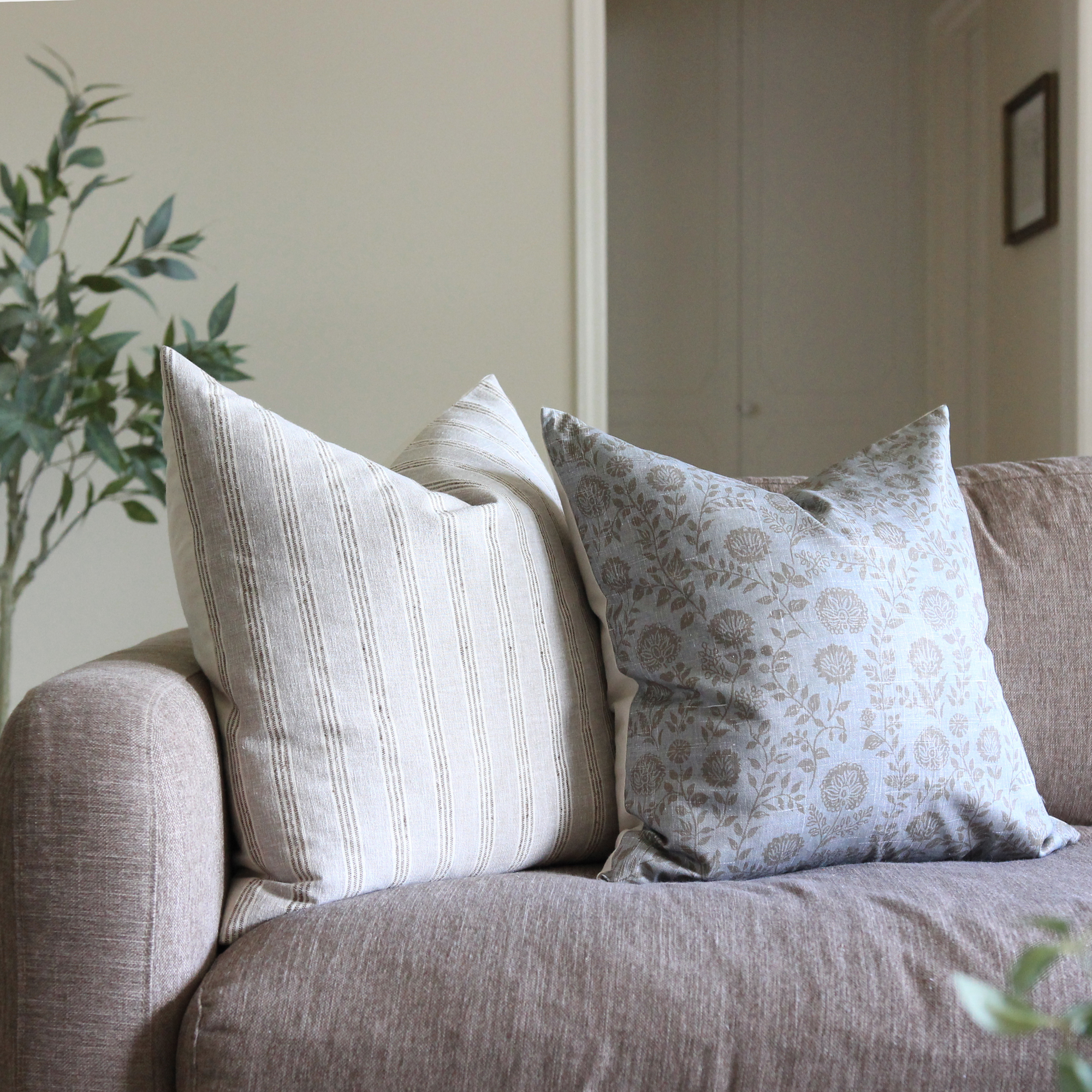 Blue gray floral pillow covers styled on gray sofa, transitional living room decor