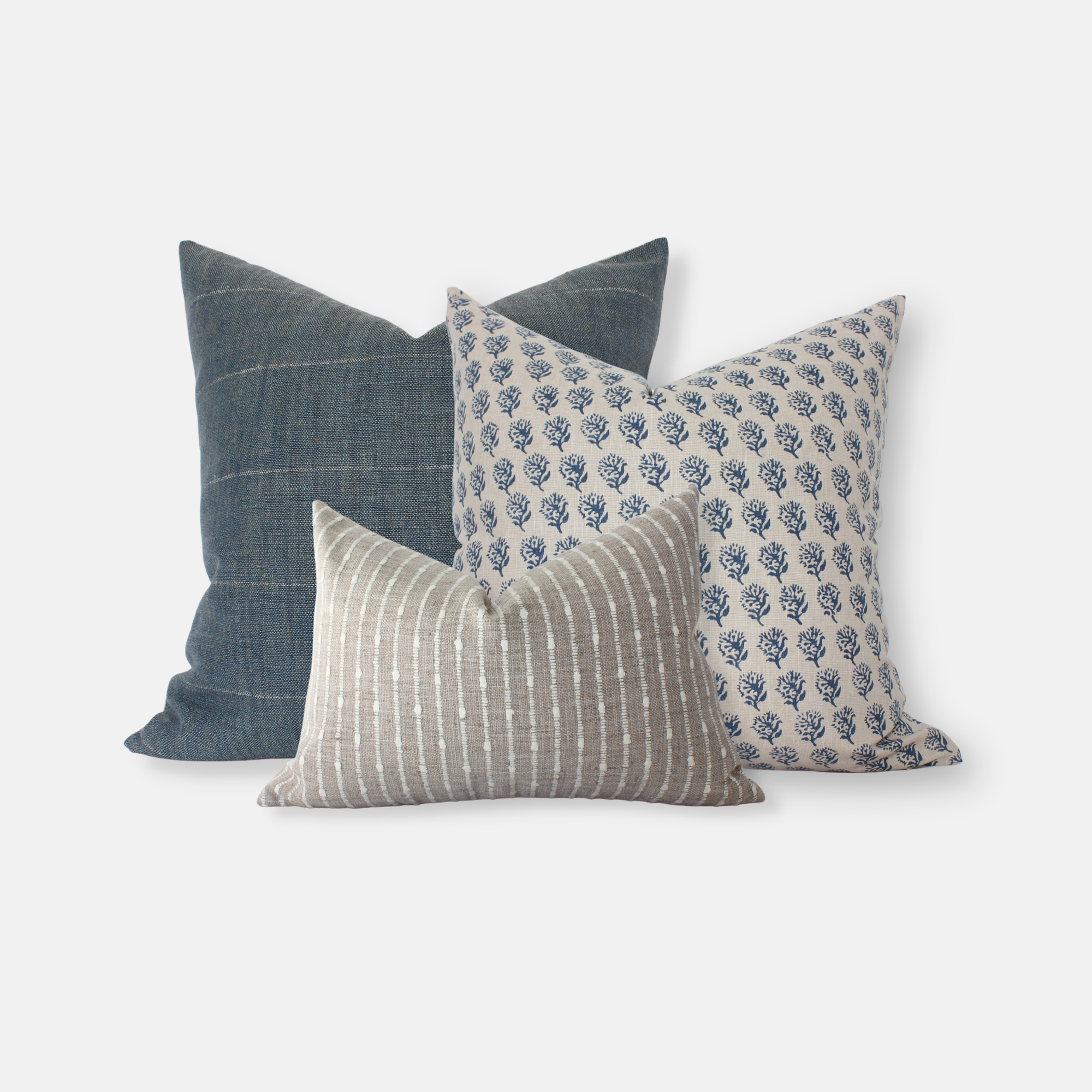 Three decorative pillows with different patterns in blue and gray on a white background