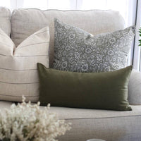 olive green lumbar pillow on sofa