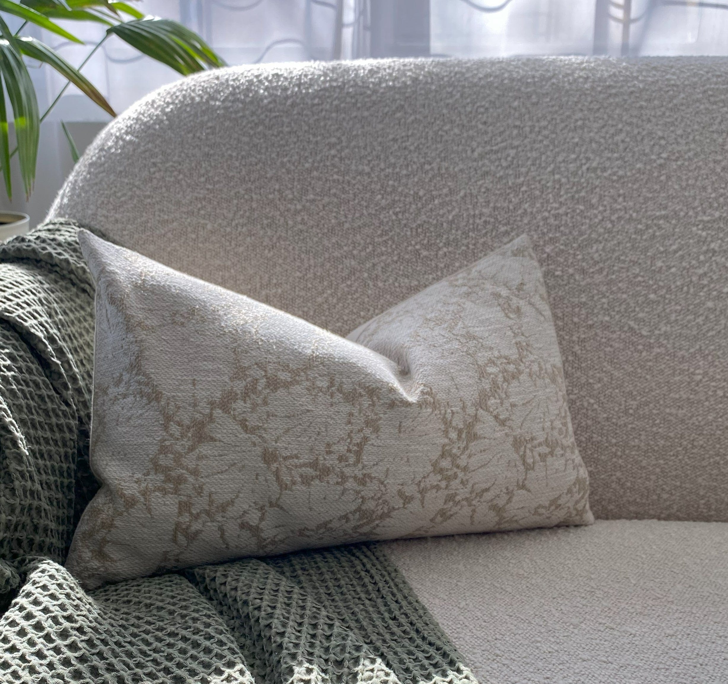 white and brown pillow cover on sofa