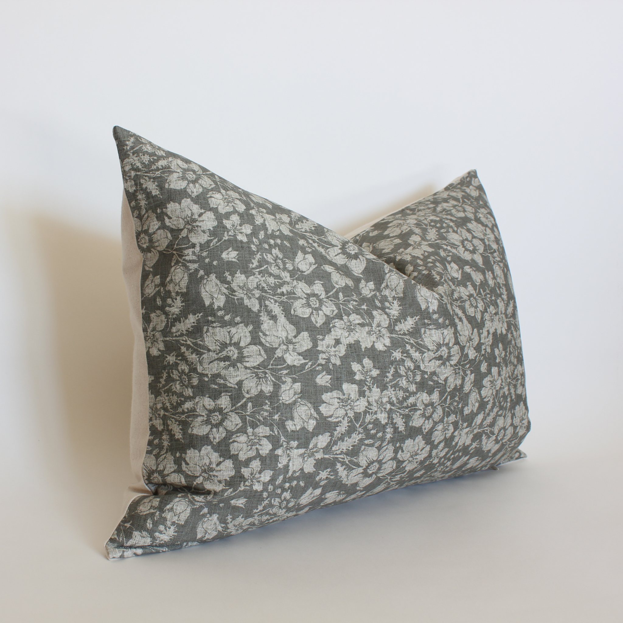 Gray floral lumbar pillow cover angled view with cream wildflower print, neutral home accent