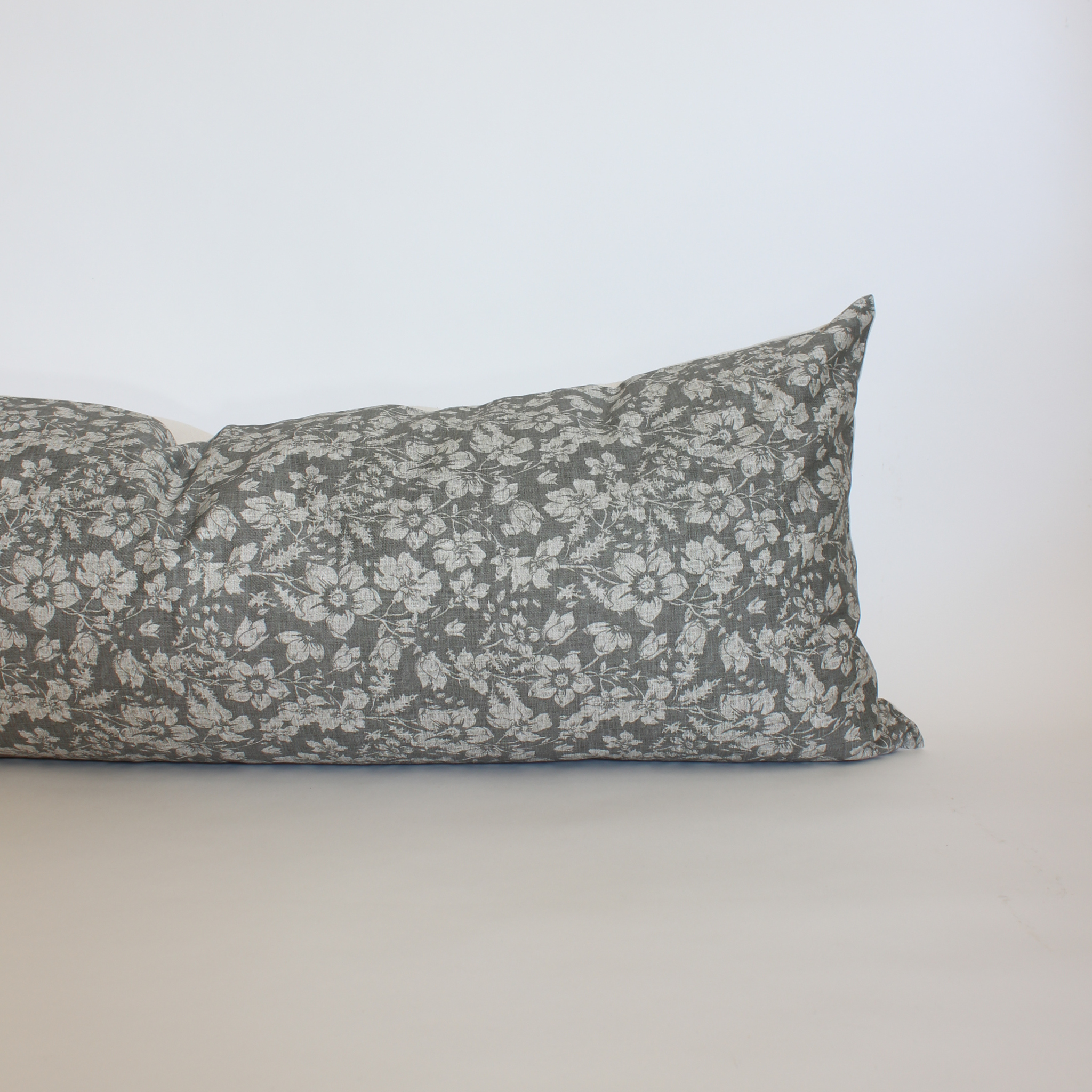 Charcoal gray floral lumbar throw pillow cover with scattered cream botanical print