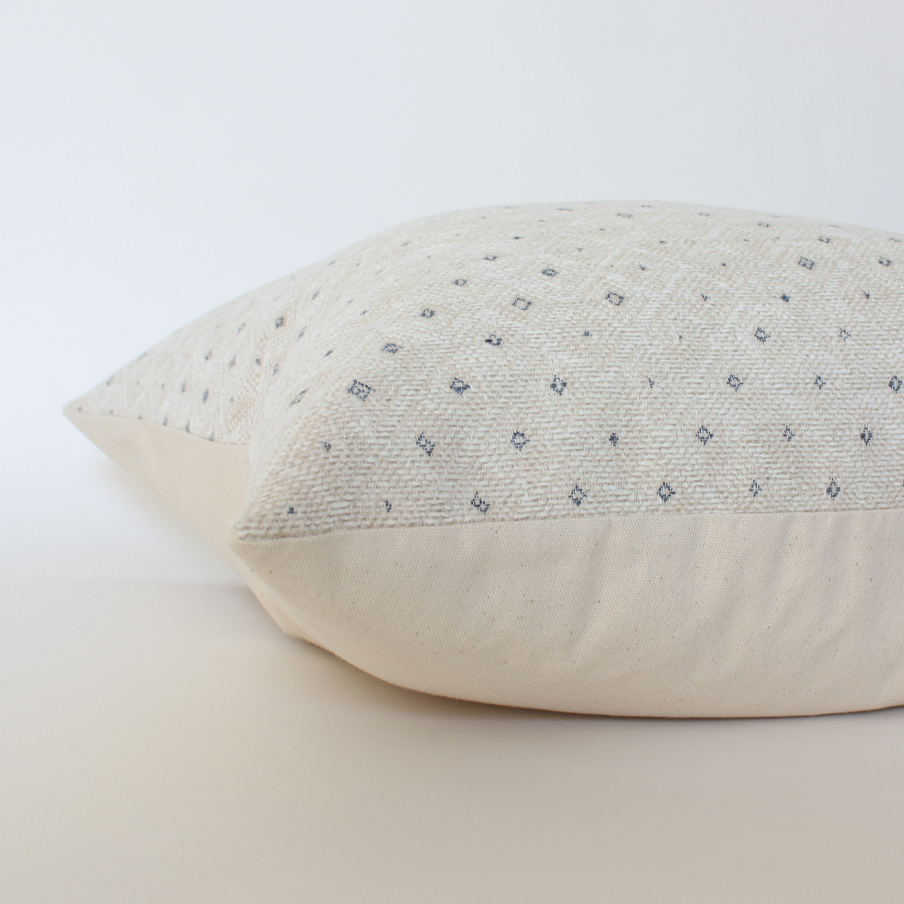 Textured pillow with subtle pattern on a light background