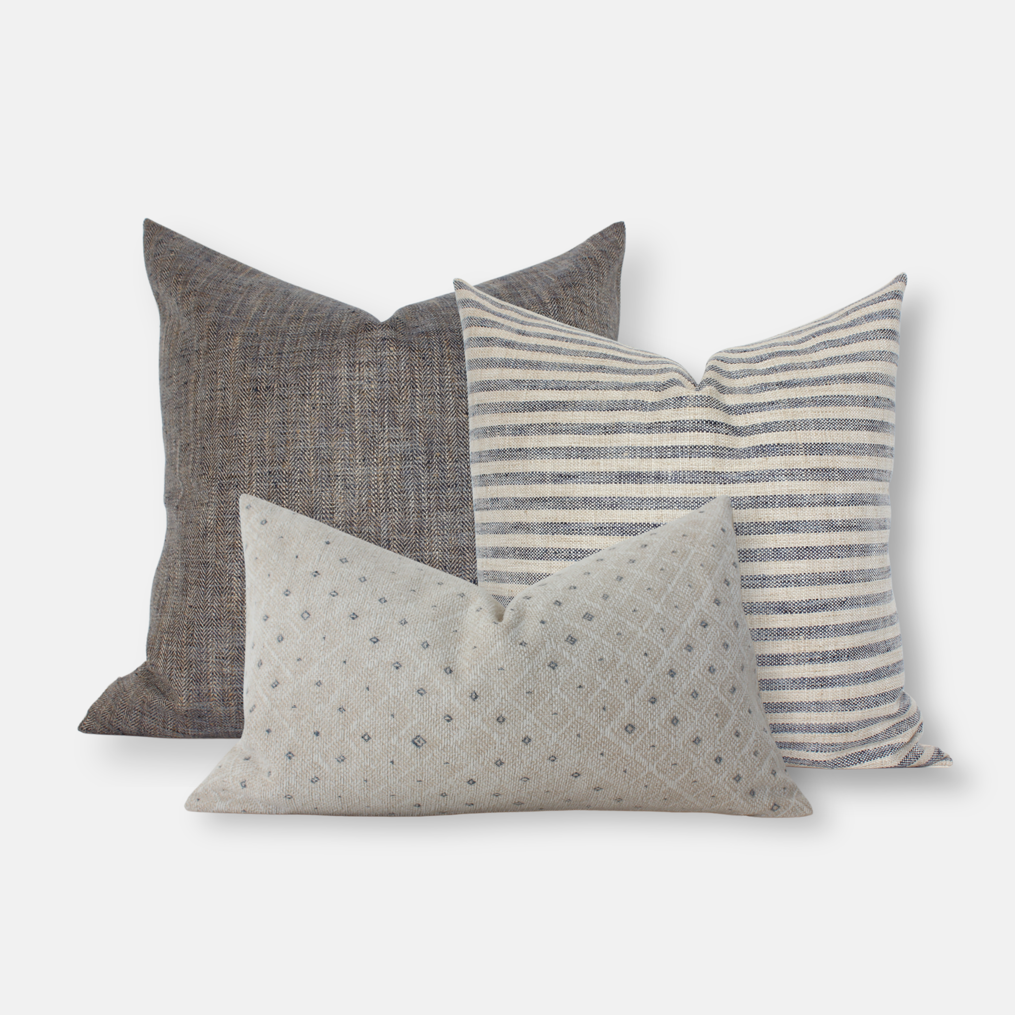 Three decorative pillows with different patterns on a white background