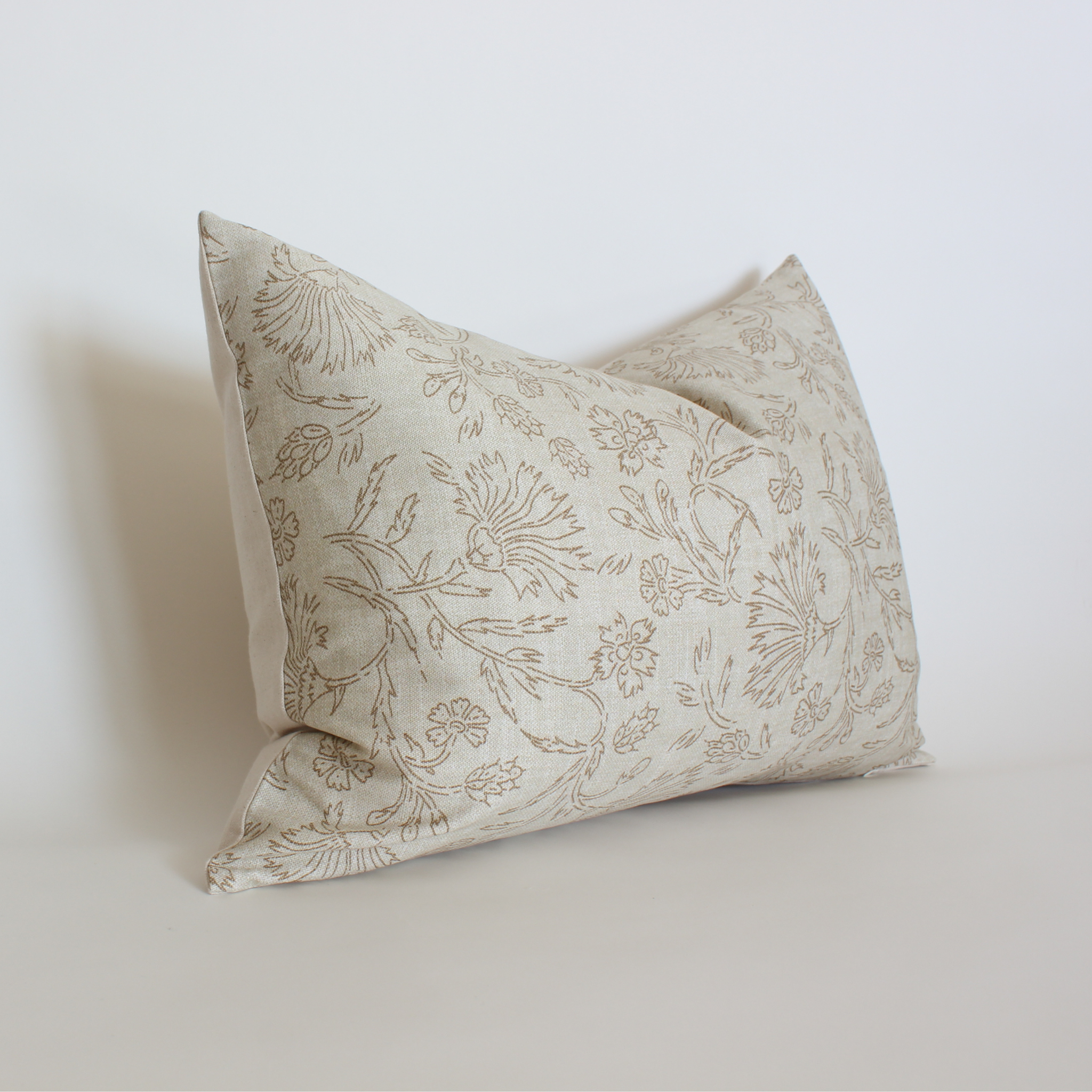 Cream and taupe floral lumbar throw pillow cover angled view, neutral transitional home accent