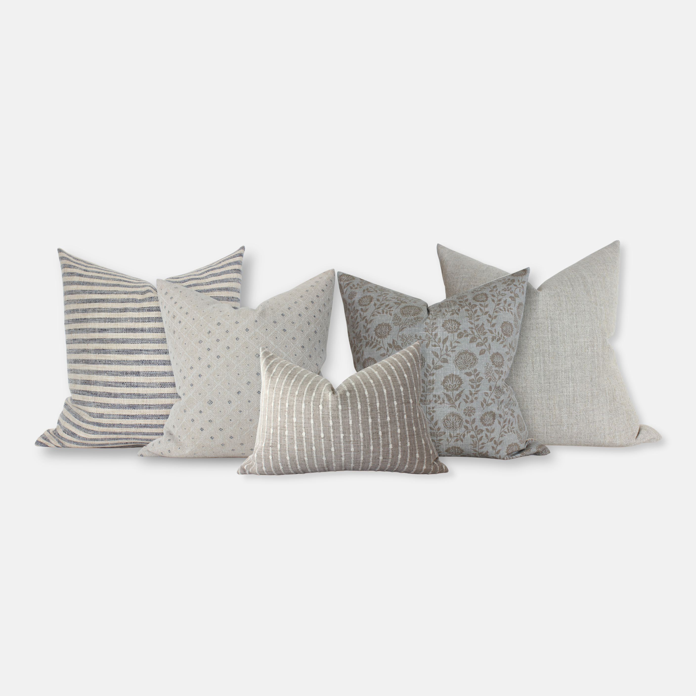Set of decorative pillows in gray and blue with various patterns on a white background