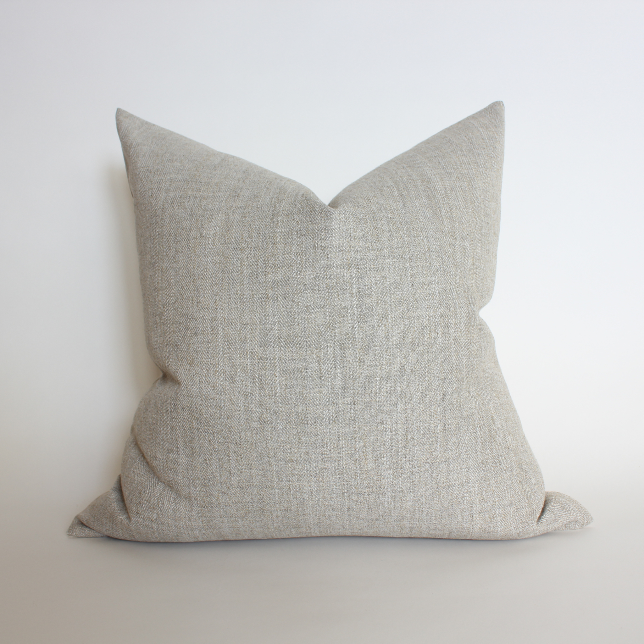 Textured gray pillow on a white background