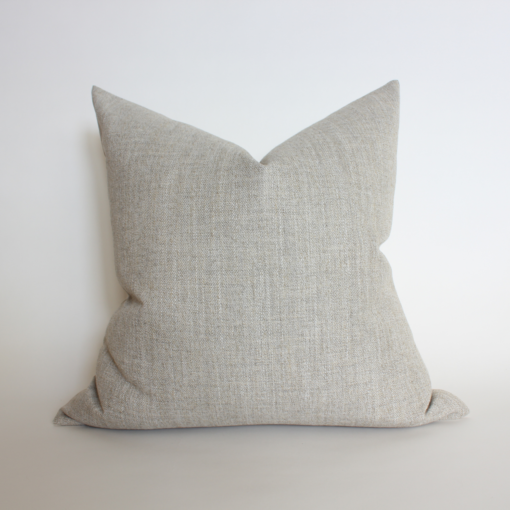 Textured gray pillow on a white background