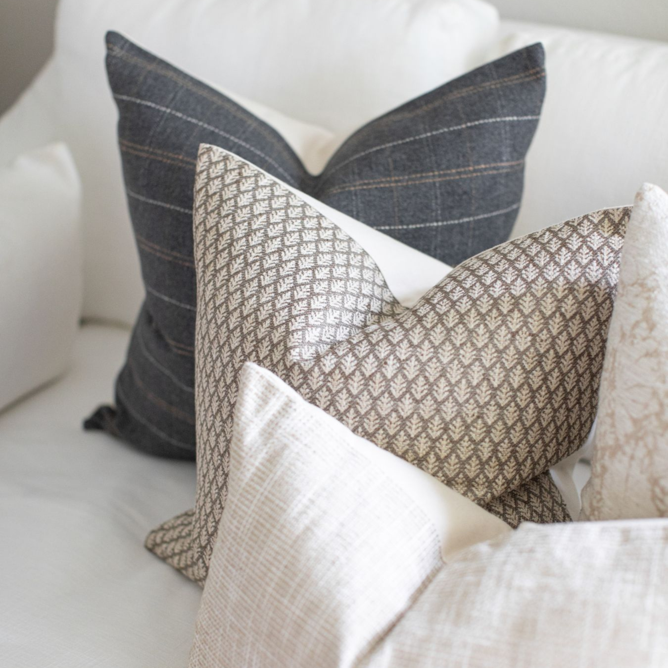 Patterned pillows on a white sofa