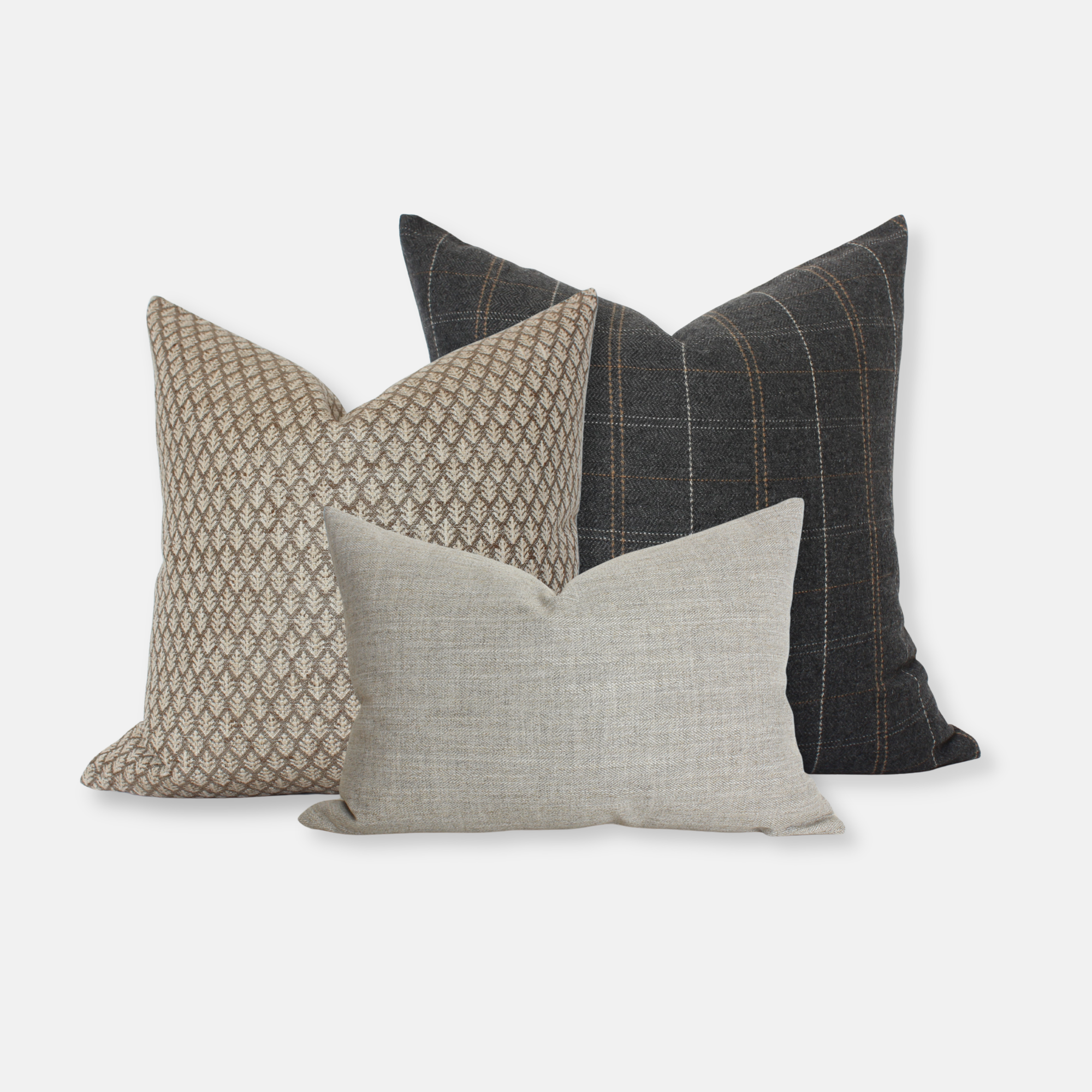 Three decorative pillows with different gray brown beige patterns on a white background