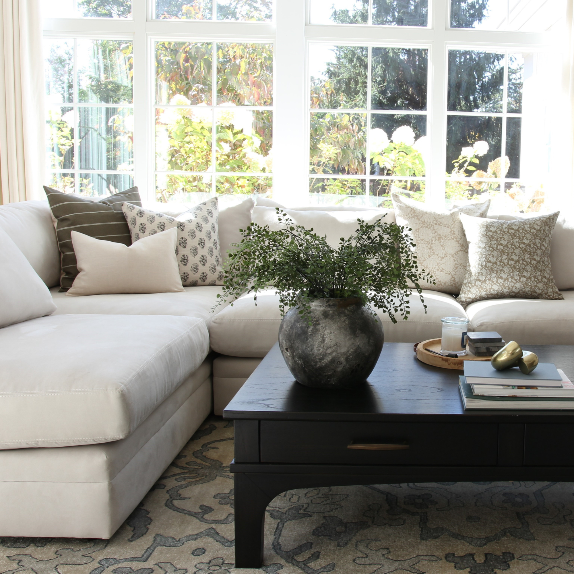 neutral pillow covers on a sectional cream sofa