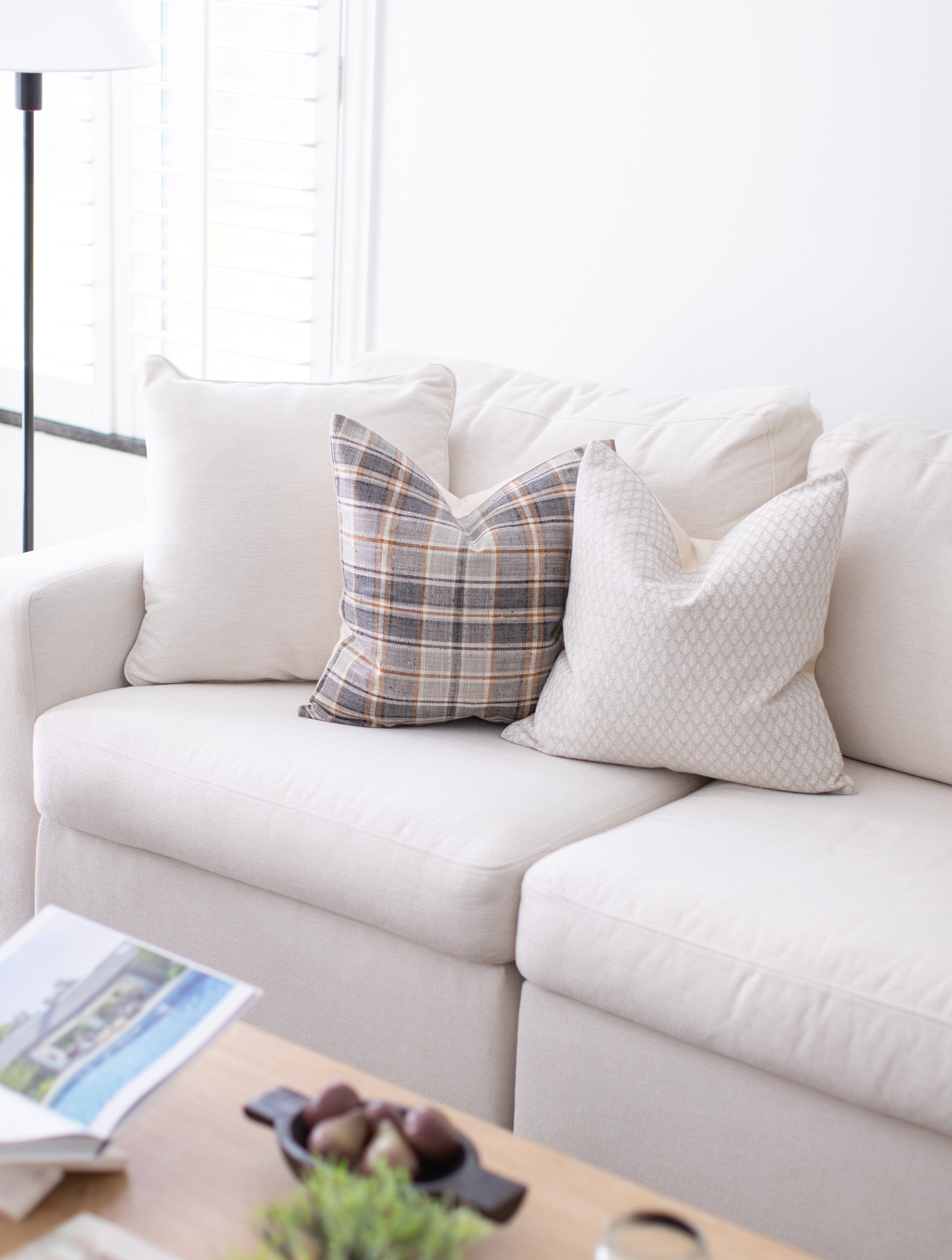 neutral pillow covers on sofa