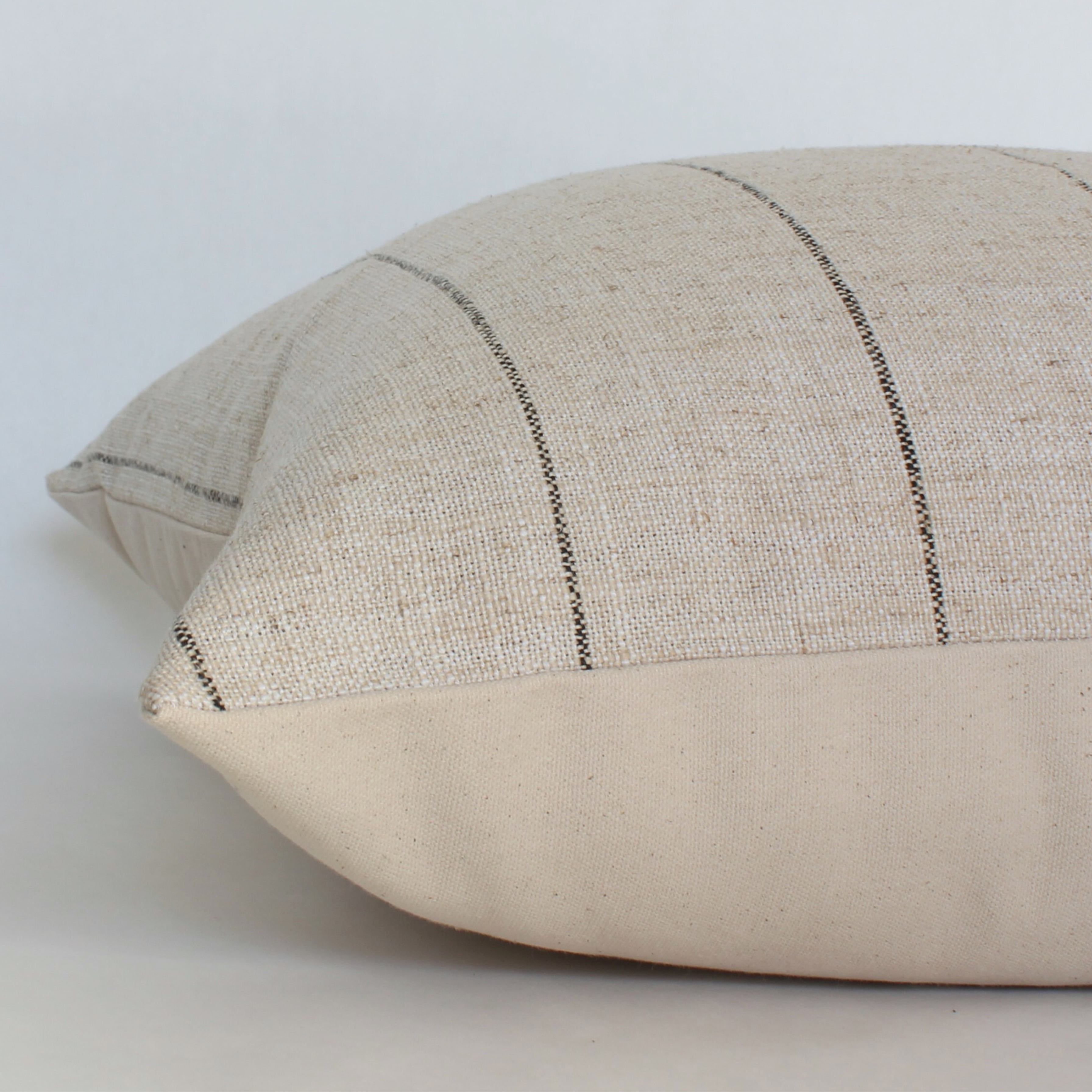 Textured pillow with a subtle pattern on a light background