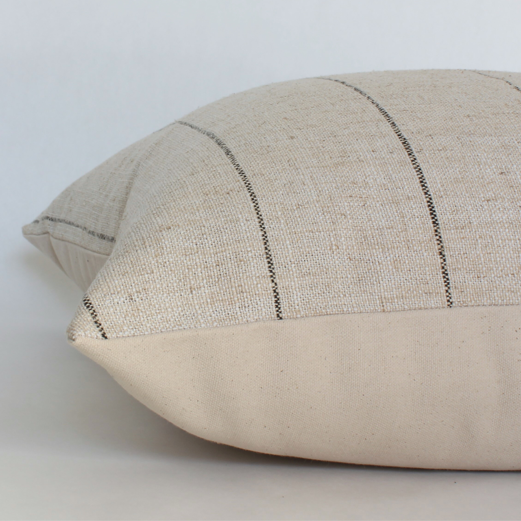 Textured pillow with a subtle pattern on a light background