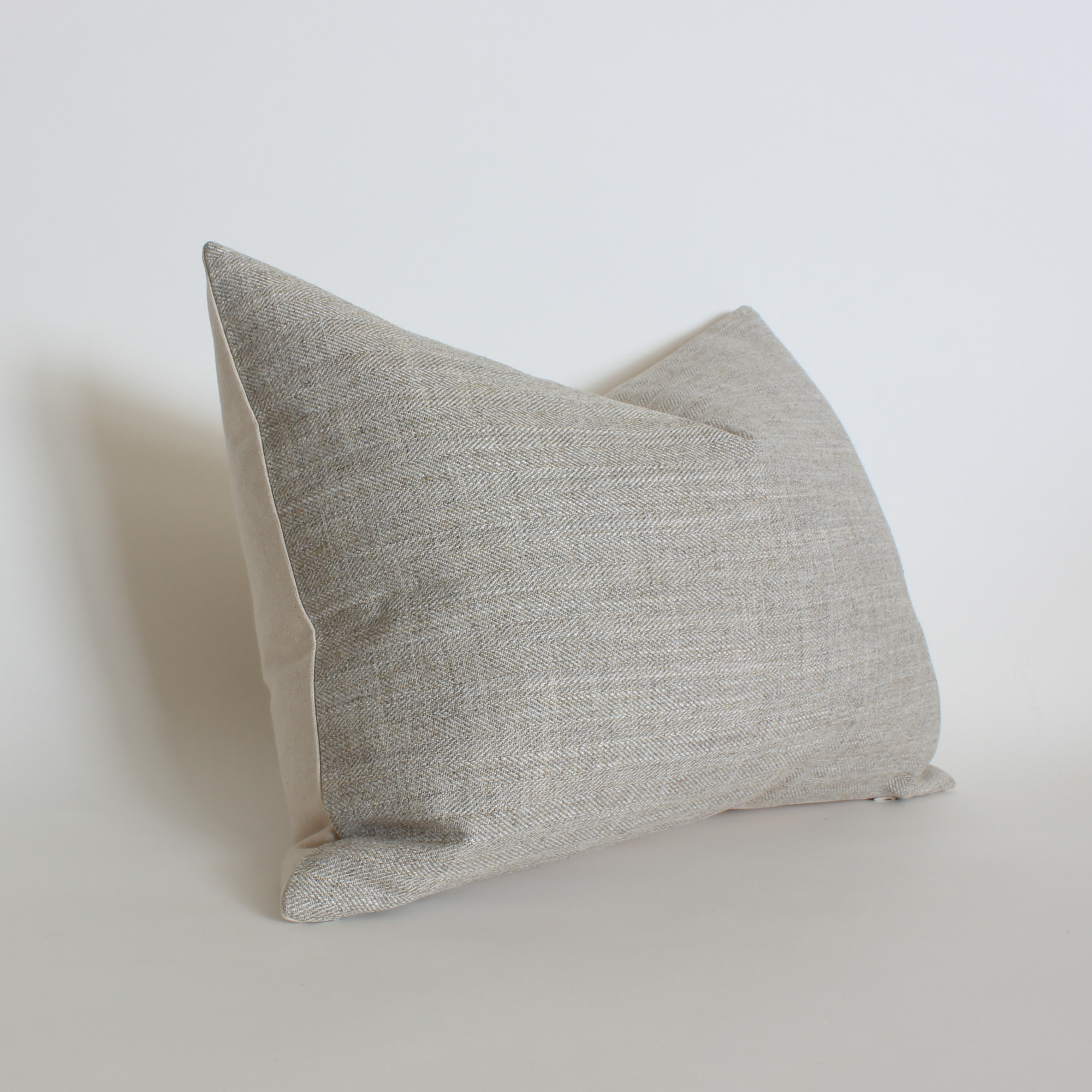 Gray textured pillow on a light gray background