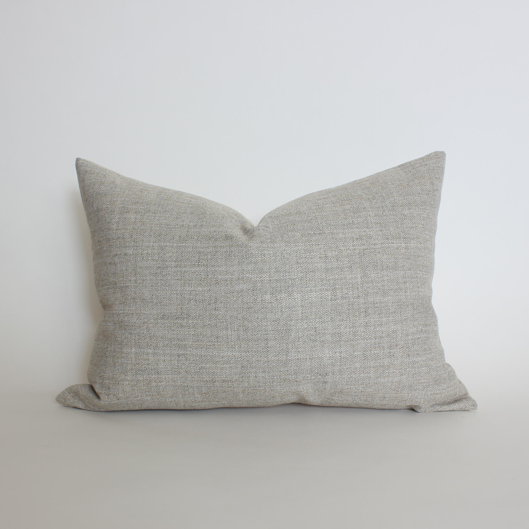 Warm gray textured lumbar throw pillow cover in woven herringbone fabric, neutral home decor