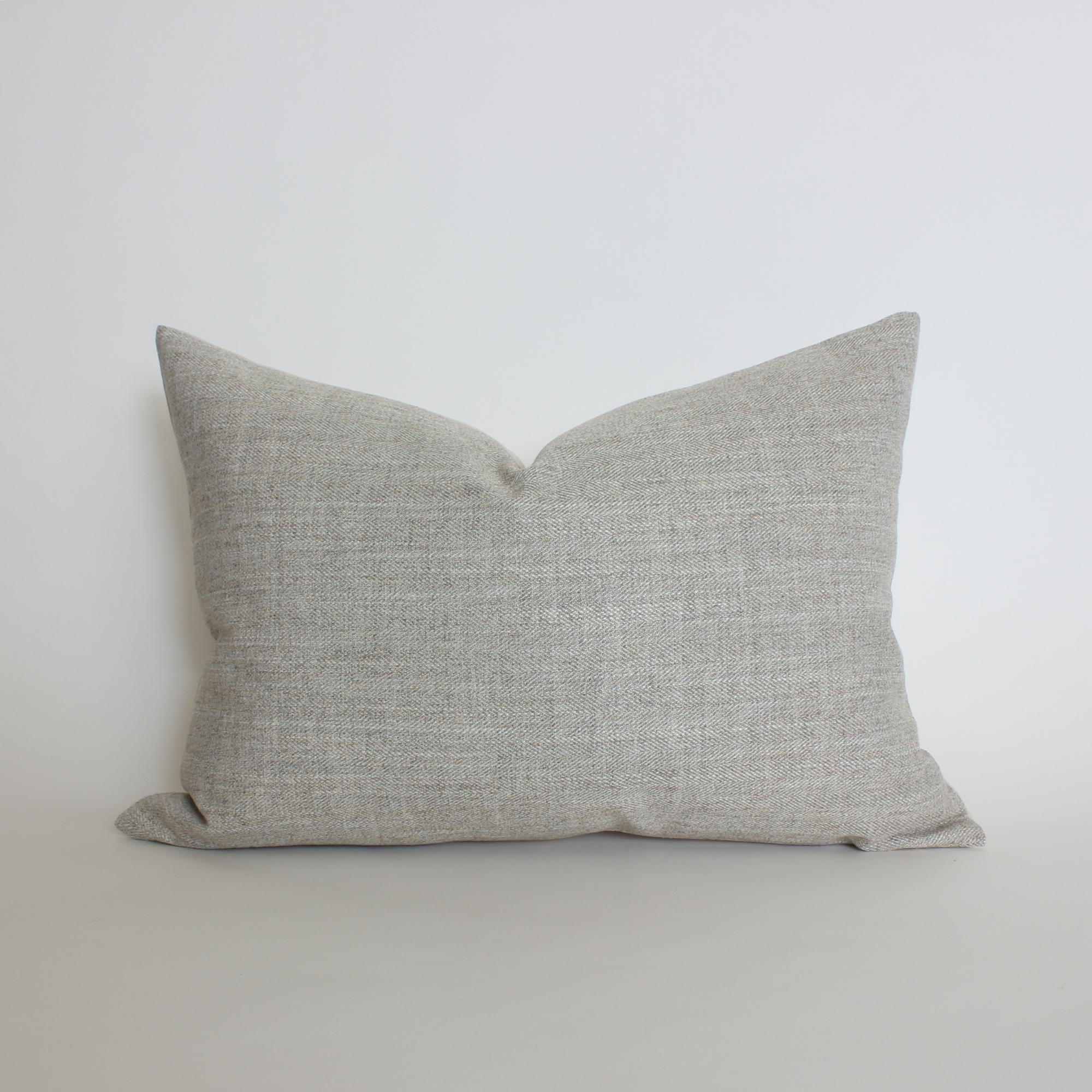 Warm gray textured lumbar throw pillow cover in woven herringbone fabric, neutral home decor
