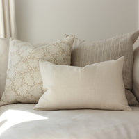 neutral throw pillows on sofa