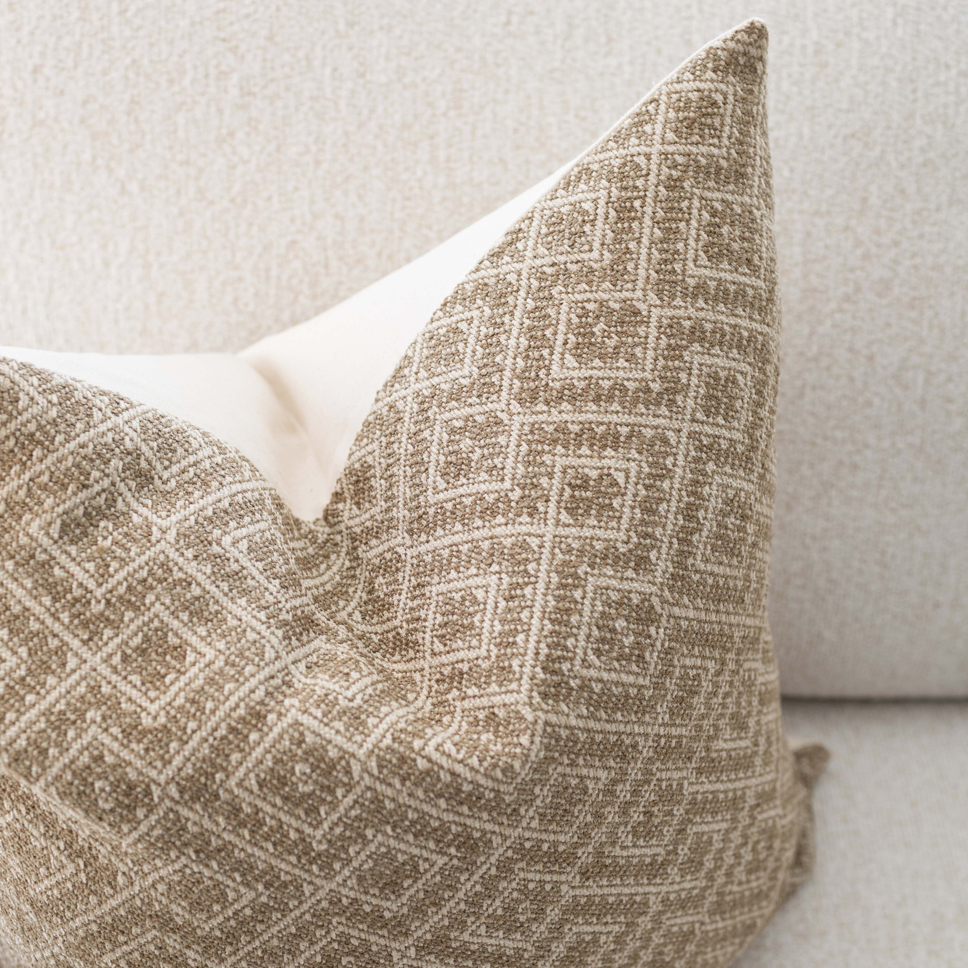 Textured patterned pillow on a neutral background