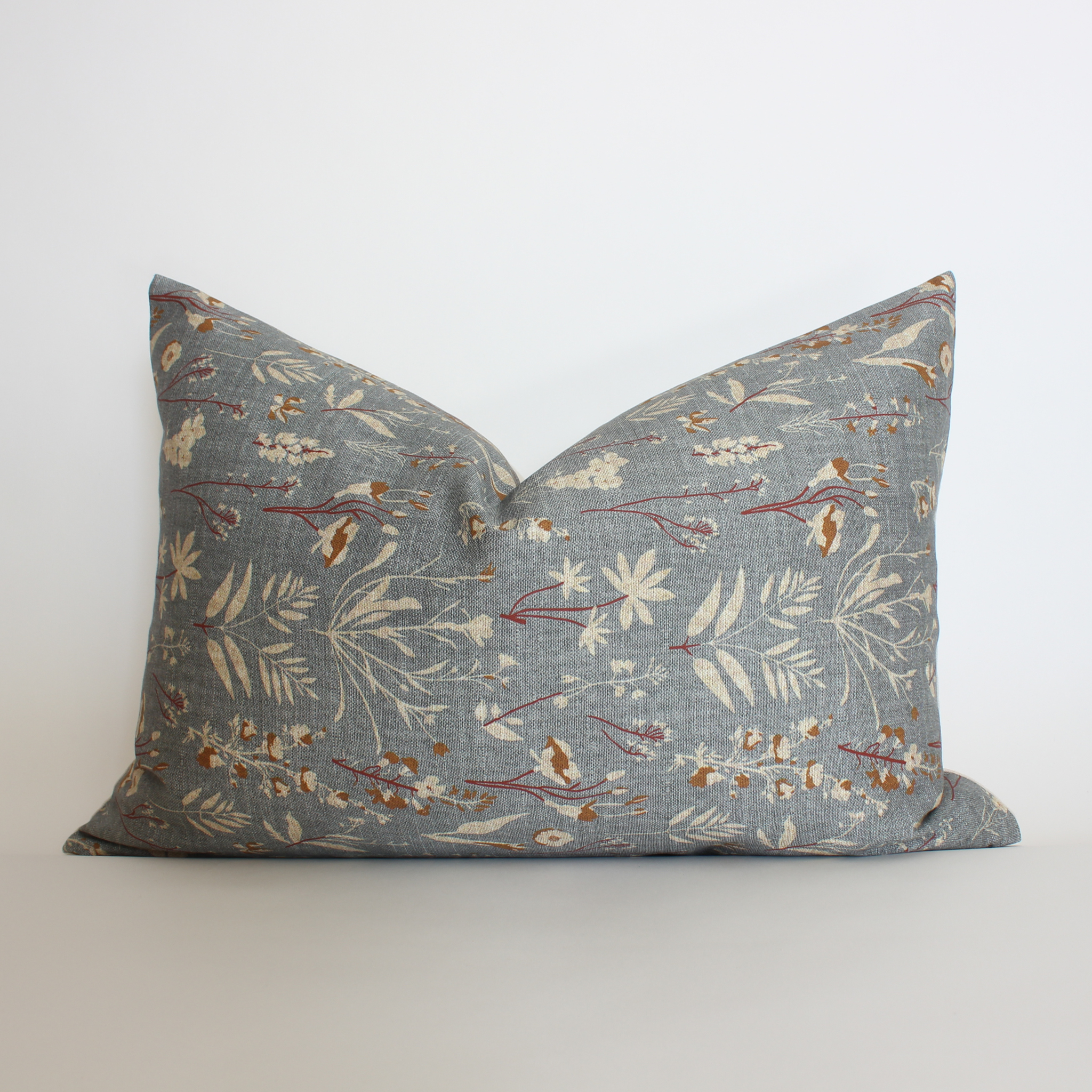 Slate blue botanical lumbar pillow cover with rust wildflower detail, neutral living room accent pillow