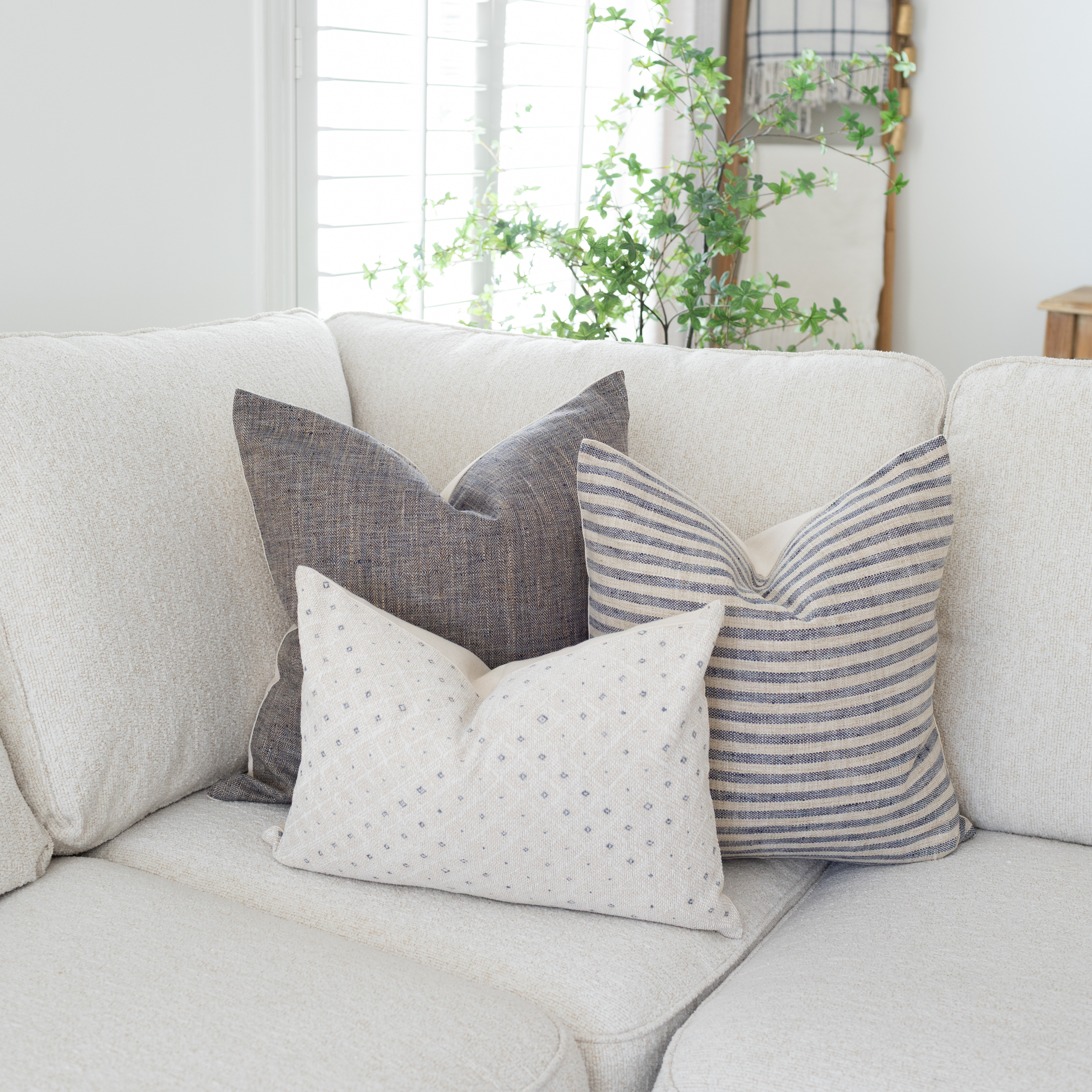 soft blue neutral throw pillows on a white sofa