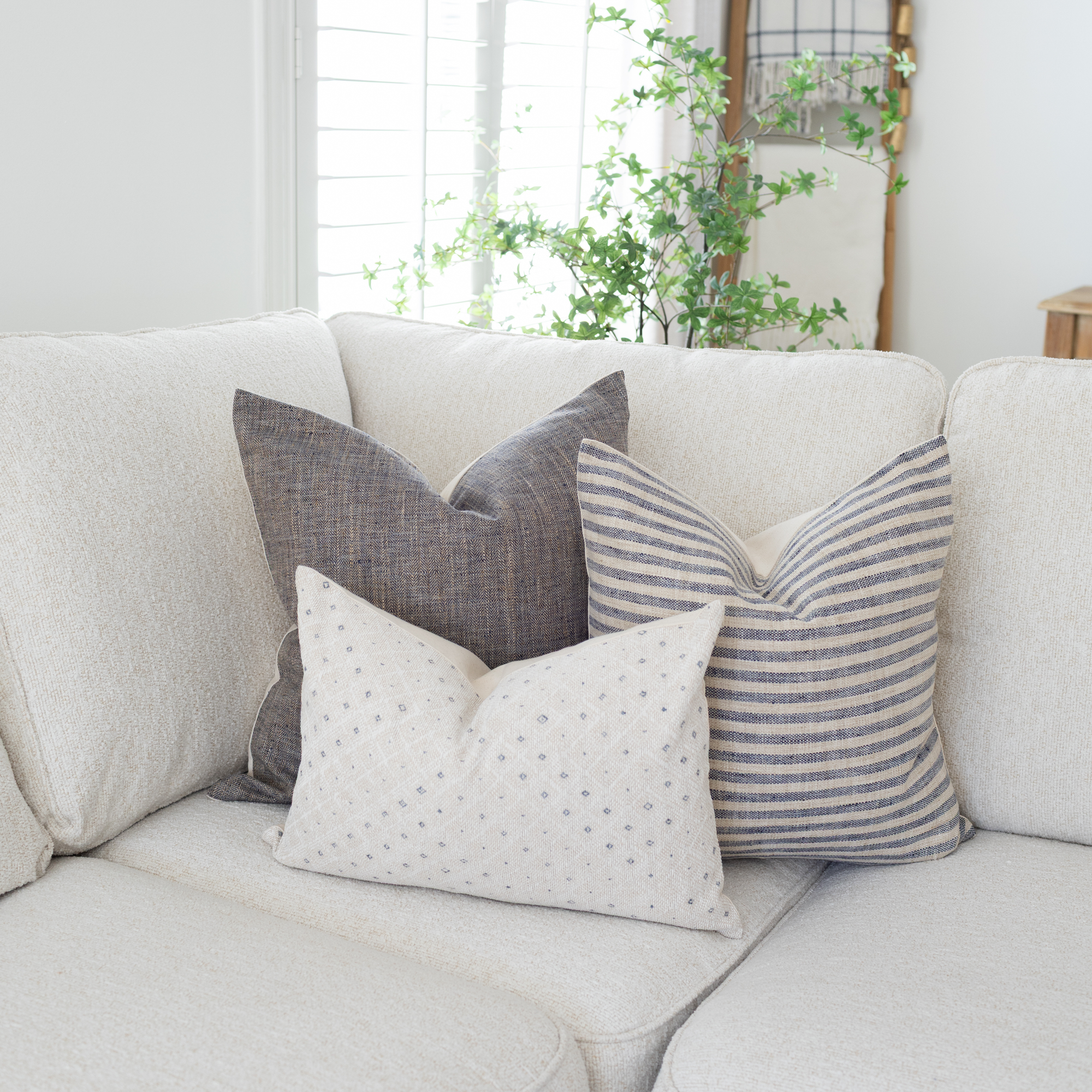 soft blue neutral throw pillows on a white sofa