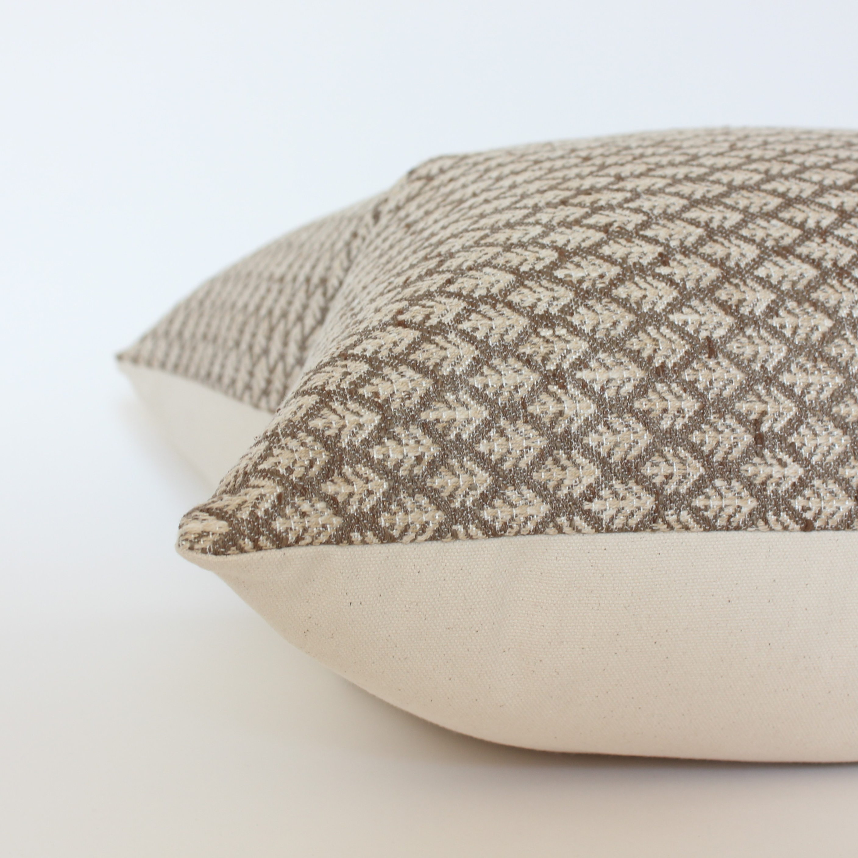 brown neutral floral pillows on a light background