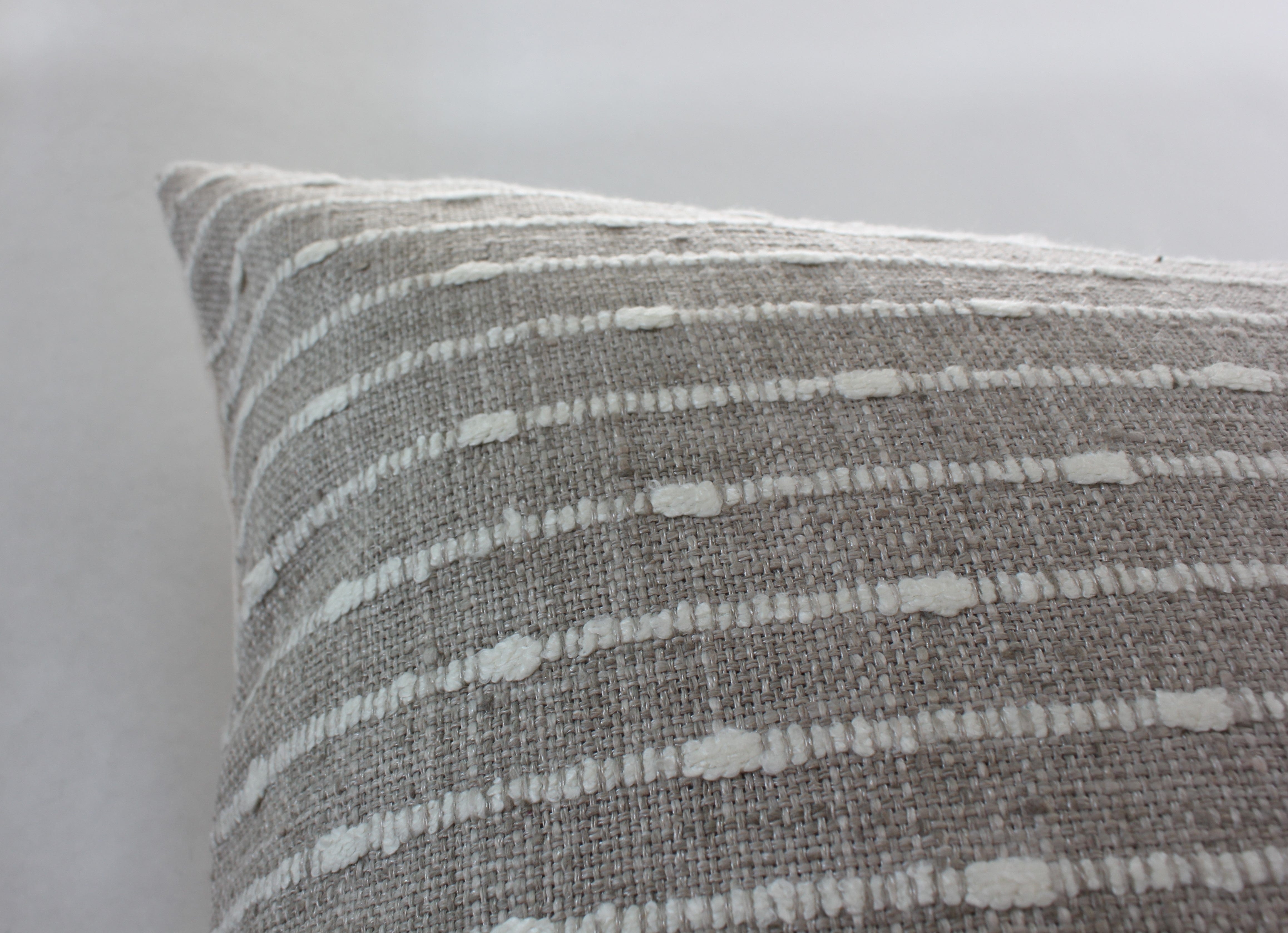 cream and white textured pillow