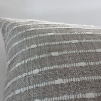 cream and white textured pillow