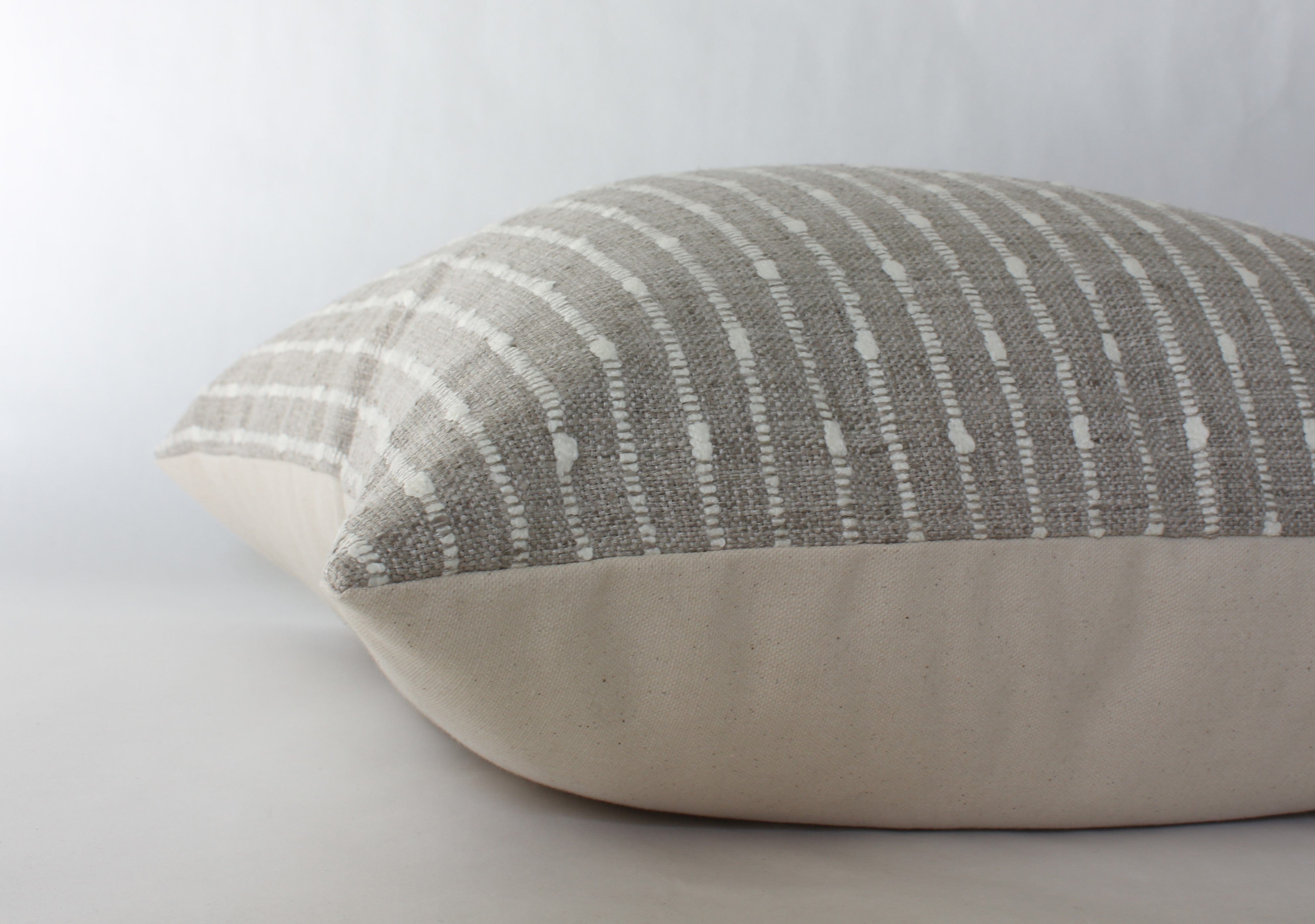 beige striped throw pillow