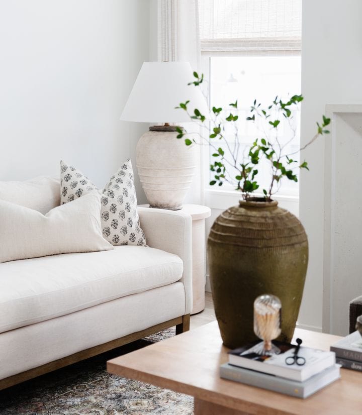 cream floral pillow on sofa